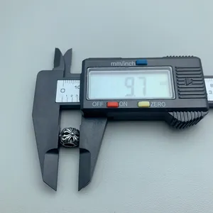 Detailed macro view of 9.7mm stainless steel floral hollow spacer bead for DIY jewelry making