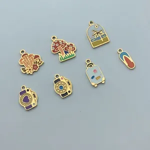 Detailed view of stainless steel enamel charms featuring mushroom and camera designs