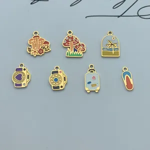 Macro view of vacation-themed enamel charms including mushroom and camera designs