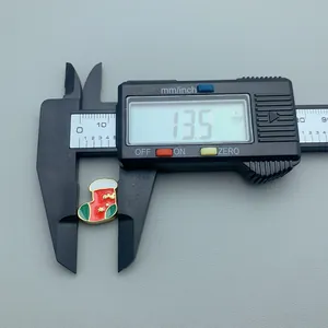 Measurement of a red enamel Christmas stocking bead using a digital caliper 13.5mm