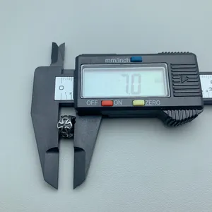 Stainless steel cross bead charm measured with digital caliper showing 7.0mm height