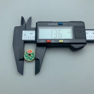 Close-up detail showing the 13.6mm diameter measurement of a festive green wreath bead