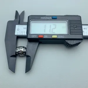Close-up of a stainless steel patterned bead measured with a digital caliper