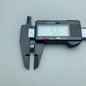 Close-up of a stainless steel star bead being measured with a digital caliper tool.