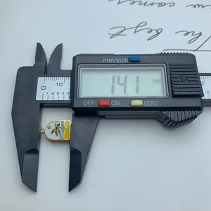Digital caliper measuring a 14.1mm enamel palm tree pendant accessory