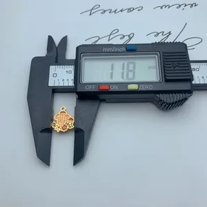 Measurement of a stainless steel mushroom charm with colorful enamel detail