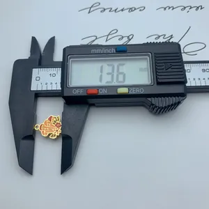 Macro view of colorful stainless steel mushroom charm measured at 13.6mm with a caliper