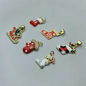 Macro detail of Christmas enamel charms with zircon inlay in sock and glove shapes