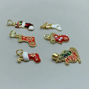 Macro detail of Christmas stocking pendants with enamel and zircon embellishments