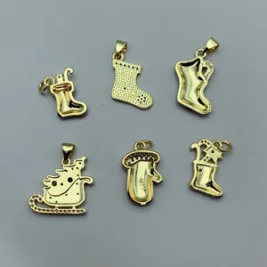 Detailed view of gold Christmas-themed jewelry pendants with zircon and enamel.