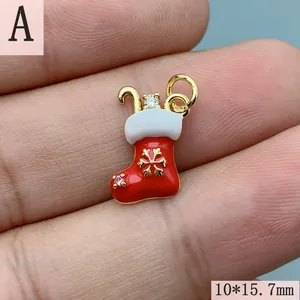 Detailed close-up of a red enamel Christmas stocking charm with gold snowflake