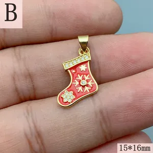 Close-up of red enamel Christmas stocking pendant with cubic zirconia snowflake detail.