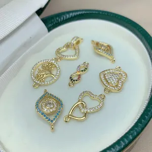 Detailed macro shot of micro-pave zircon jewelry charms in gold heart and evil eye styles