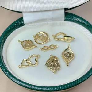 Detailed view of gold-plated micro-pave heart and evil eye DIY jewelry charms collection
