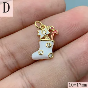 Gold Christmas stocking pendant with white enamel and zircon, 10x17mm on hand.