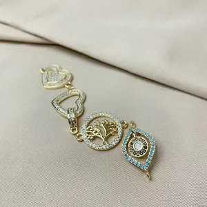 Detail of heart, tree of life and evil eye charms with micro-pave cubic zirconia