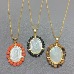 Detailed shot of Virgin of Guadalupe necklaces featuring white shell and gemstone beads