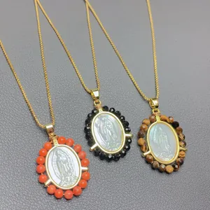 Detailed view of three Virgin of Guadalupe necklaces with colorful bead surrounds