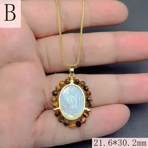 Detailed view of Our Lady of Guadalupe pendant with tiger eye beads and gold chain
