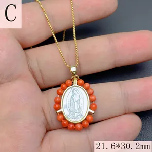 Macro detail of Our Lady of Guadalupe mother of pearl oval pendant with orange bead border