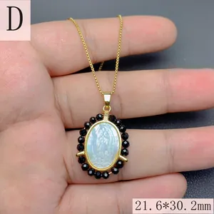 Detail of Virgin Mary Guadalupe pendant necklace with white mother of pearl and black beads