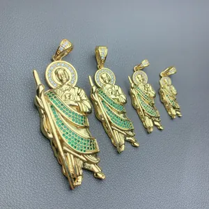 Detailed macro view of gold-plated Saint Jude pendants with green micro-pave CZ stones.