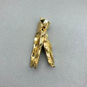 Detailed side view of gold St. Jude Thaddeus pendant with micro-set green zircons