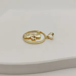 Close-up of white mother-of-pearl angel pendant with gold-plated frame