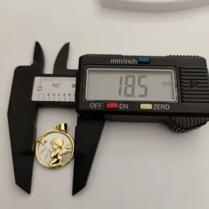 Close-up showing the 18.5mm diameter measurement of the mother of pearl angel pendant.