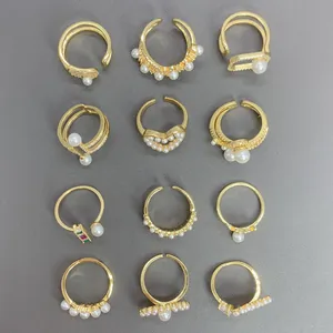 Colección de anillos dorados con perlas y circones en diseños de corazón y ojo
