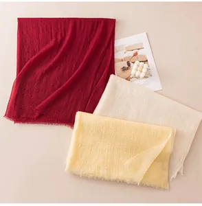 Macro view of soft lightweight cashmere scarves in red, cream and yellow colors