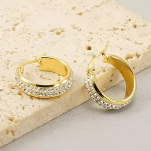 Close-up detail of gold-plated hoop earrings with double row sparkling rhinestones