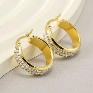 Close-up of 18K gold plated hoop earrings featuring double-row rhinestone pavé detail