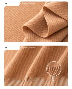 Macro view showing the camel wool blend fabric texture and delicate fringe tassel details