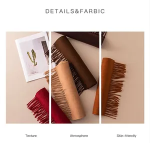 Detailed view of soft wool scarves with tassels in various autumn colors