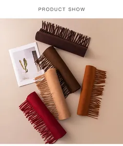 Detail view of colorful solid wool-like fringe scarves in warm autumn and winter tones