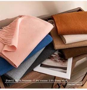 Detail view of soft wool blend scarves in various colors showing warm fabric and fringe