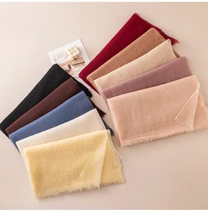 Detailed view of multiple solid cashmere scarves in soft spring colors