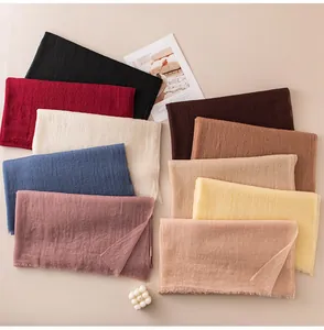Detailed view of lightweight solid color cashmere scarves in multiple elegant shades.