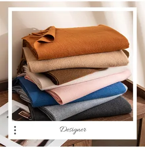 Detailed view of soft wool blend scarves with fringe detail in various fashion colors