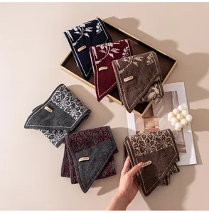 Collection of premium knitted jacquard triangle scarves in various colors on a tray
