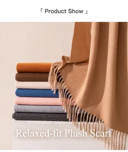 Macro view of a stack of soft minimalist solid-colored wool scarves with tassel edges