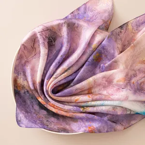 Close-up of premium mulberry silk scarf with artistic purple oil painting print.
