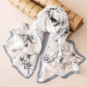 Elegant silk scarf featuring a Chinese ink-wash bamboo print with a decorative scroll.