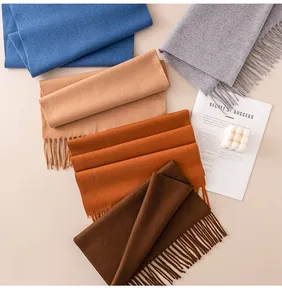 Macro view showing a collection of solid wool scarves with tassels in elegant autumn colors