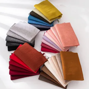 Wide variety of folded solid color wool scarves in multiple elegant autumn tones