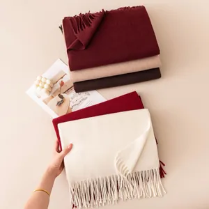 Folded solid color wool blend scarves with tassels in various autumn colors