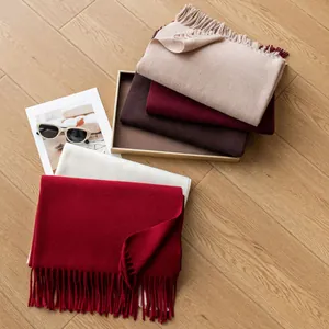 Detailed shot showing various colors of wool blend scarves with elegant fringe.