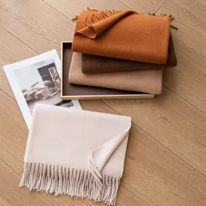 Warm wool-like winter scarves with tassels in various earth-tone colors.