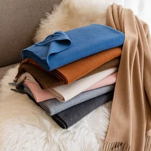 Multi-color solid wool pashmina scarves with fringe for women in a cozy winter setting.